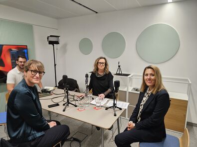 3 Frauen und 1 Mann um den Tisch bei der Podcast-Aufnahme